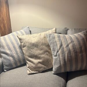 Pottery Barn 2 blue and cream striped and 1 floral pillow set.